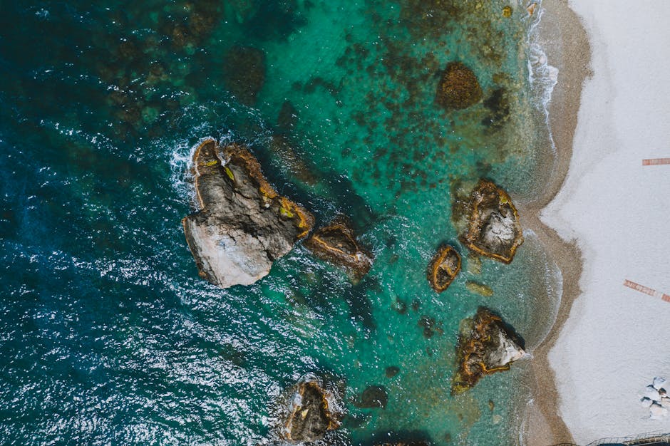 Stunning aerial shot of Berehove beach with turquoise waters and rocky shore. Perfect for travel and nature themes.
